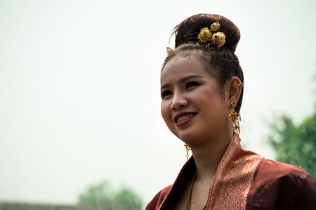 Chiang Rai, Thailand - April 13, 2018 : Songkran festival at Suan Tung Lae Khom Chiang Rai Park in Chiang Rai.  Girl enjoy with splashing water.のeditorial素材