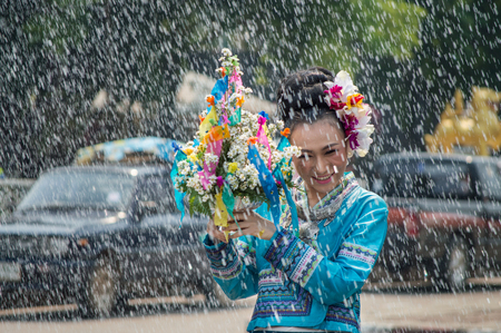 Chiang Rai, Thailand - April 13, 2018 : Songkran festival at Suan Tung Lae Khom Chiang Rai Park in Chiang Rai. Girl enjoy with splashing water.のeditorial素材
