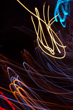 Abstract light painting photography, curves and waves abstract light against a black backgroundの写真素材