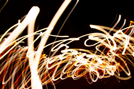 Abstract light painting photography, curves and waves abstract light against a black backgroundの写真素材