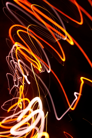 Abstract light painting photography, curves and waves abstract light against a black backgroundの写真素材