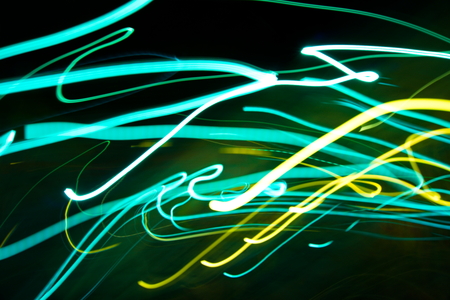 Abstract light painting photography, curves and waves abstract light against a black backgroundの写真素材