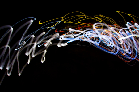 Abstract light painting photography, curves and waves abstract light against a black background