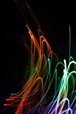 Abstract light painting photography, curves and waves abstract light against a black backgroundの写真素材