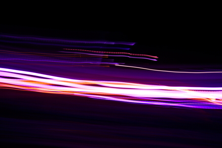 Abstract light painting photography, curves and waves abstract light against a black backgroundの写真素材