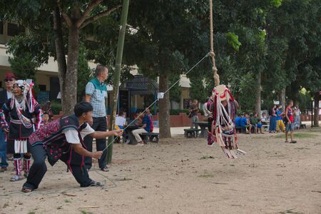 Chiang Rai, THAILAND, September 21, 2019 : Akha tribe playing with the wooden swing on Akha Swing Festival.のeditorial素材