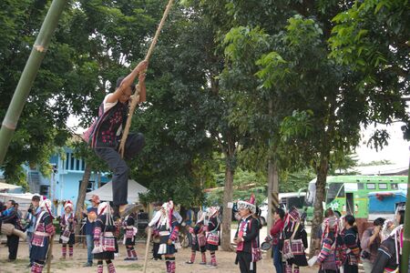Chiang Rai, THAILAND, September 21, 2019 : Akha tribe playing with the wooden swing on Akha Swing Festival.のeditorial素材