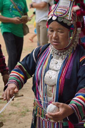 Chiang Rai, THAILAND, September 21, 2019 : The Akha Swing Festival, demonstration of how to making Akha traditional spinning yarn.のeditorial素材