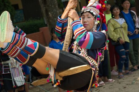 Chiang Rai, THAILAND, September 21, 2019 : Akha tribe playing with the wooden swing on Akha Swing Festival.のeditorial素材