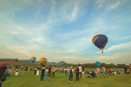 Chiang Rai, Thailand %u2013 December 1, 2019: A hot air balloons flying over travelers in Singha Park Chiang Rai during Farm festival on the hill 2019.のeditorial素材