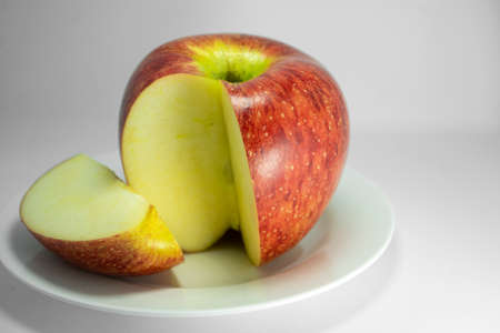 Fresh apple. Closeup studio shot isolated on a white dish.