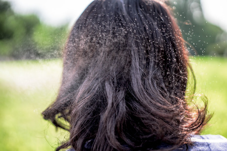 Splashing water on black hair of asian girlの写真素材