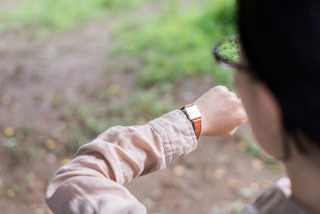 Asian woman looking at her watchの写真素材