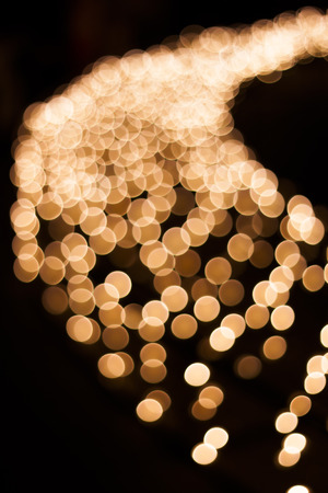Warm colors and light spots on a black background