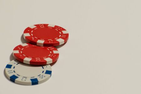 Red and white poker chips on a white backgroundの写真素材