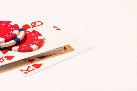 King- and Queen of Hearts with red and white poker chips on a white backgroundの写真素材