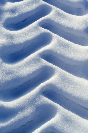 old tractor tyre marks in snowの写真素材