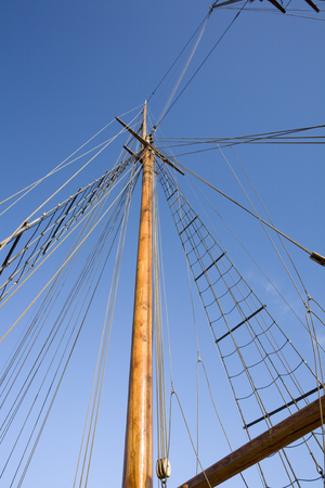 sailing ship ropes against blue sky
