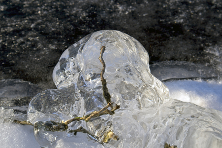 ice covered wire mesh on lakeshore breakwater, Finlandの写真素材