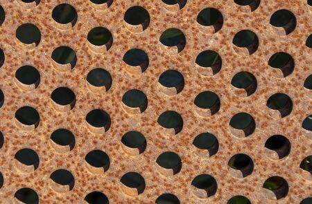 rusty metal plates with holesの写真素材