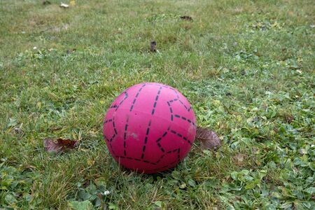 red plastic soccer ball on lawn