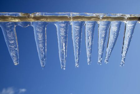 clear icicles against blue skyの写真素材