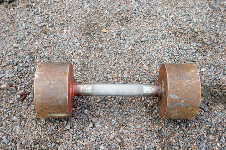 metallic dumbbell on ground outdoorsの写真素材