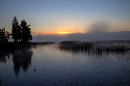 sunrise at a misty lake, Suomenniemi Finlandの写真素材