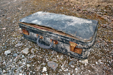 Old abandoned suitcase outdoors