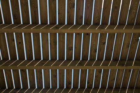 Sun streams across gaps in wooden structure