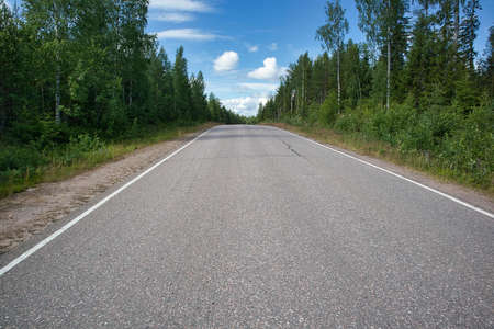 Empty asphalt road in rural landscape, Finland