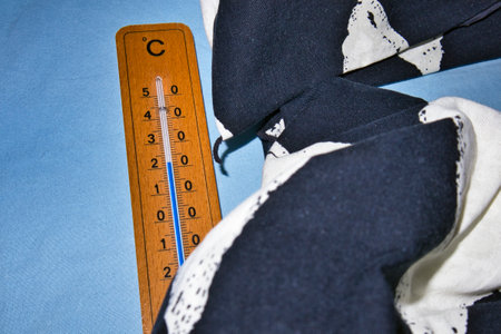 thermometer on empty bed measuring room temperatureの写真素材