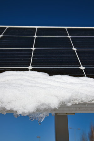 snow melting on solar panels in sunshineの写真素材