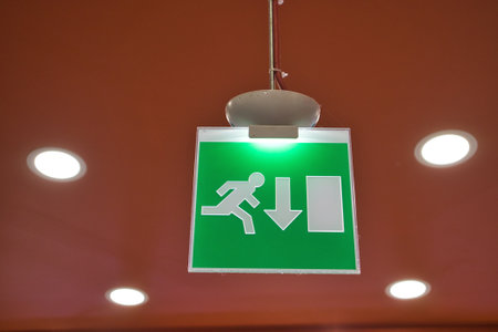 Green emergency exit sign indoorsの写真素材