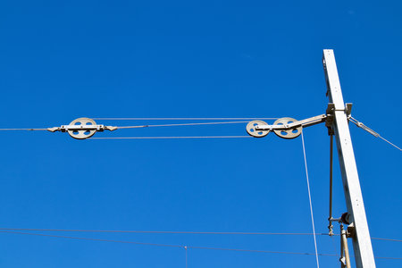 Railroad switch counter weight mechanism against blue skyの写真素材