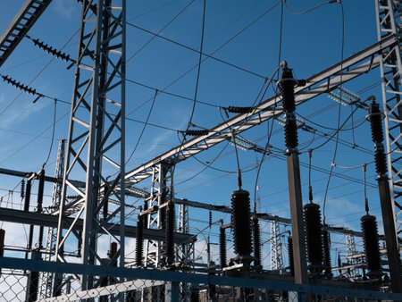 high-voltage power lines of transformer substation against the blue sky