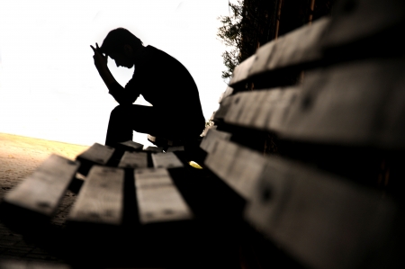 Young man sitting looking upsetの写真素材