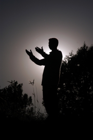 praying man silhouette standingの写真素材