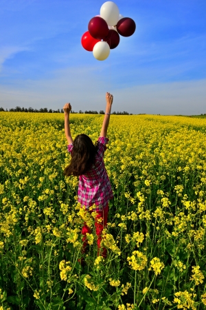 young girl playing with balloonsの写真素材