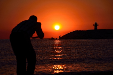 A photographer taking a photo on the beachの写真素材