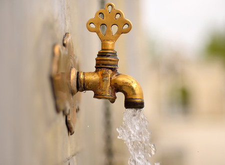 Antique Turkish faucet on wallの写真素材