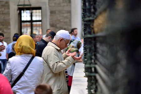 ISTANBUL, TURKEY - JUNE 23  Eyup Sultan Tomb praying in front of a crowd of people  on June 23, 2014 in Istanbul, Turkey  Close friend of the Prophetのeditorial素材