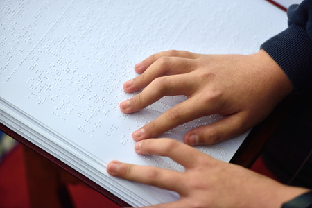 Blind child read book written in Brailleの写真素材