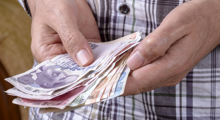 Turkish lira held on a white backgroundの写真素材