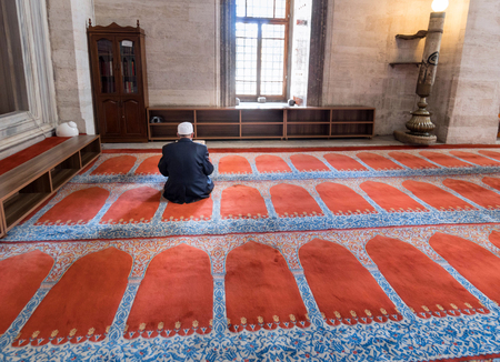 ISTANBUL, TURKEY - APRIL 13: Suleymaniye mosque muslim read koran in front of the window, 13 April 2017 in Istanbul Turkey. The Suleymaniye Mosque is the largest mosque in the city, and one of the best-known sights of Istanbul.のeditorial素材