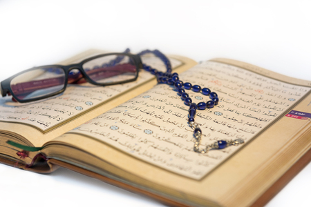 The blue rosary and glasses on the Qur'an.の写真素材