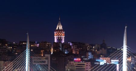 ISTANBUL, TURKEY - JUNE 10, 2018: Illuminated Galata Tower in Istanbul, Turkey with dark blue sky at...