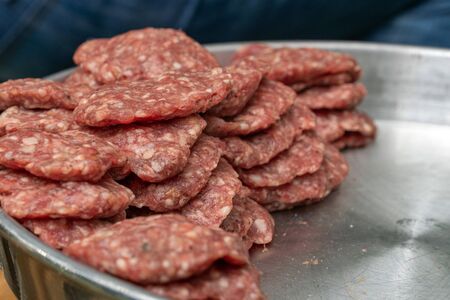Turkish uncooked Meatballs or Kofta made with Minced Meat on Wooden Surface. Different kinds of turkish traditional meal Kofta on a light cutting.の写真素材