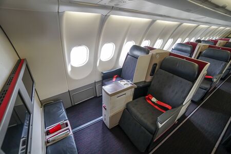 Seats of business class inside airplane.