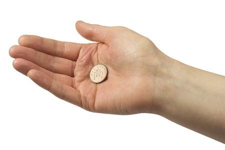 Hand holding one pence piece